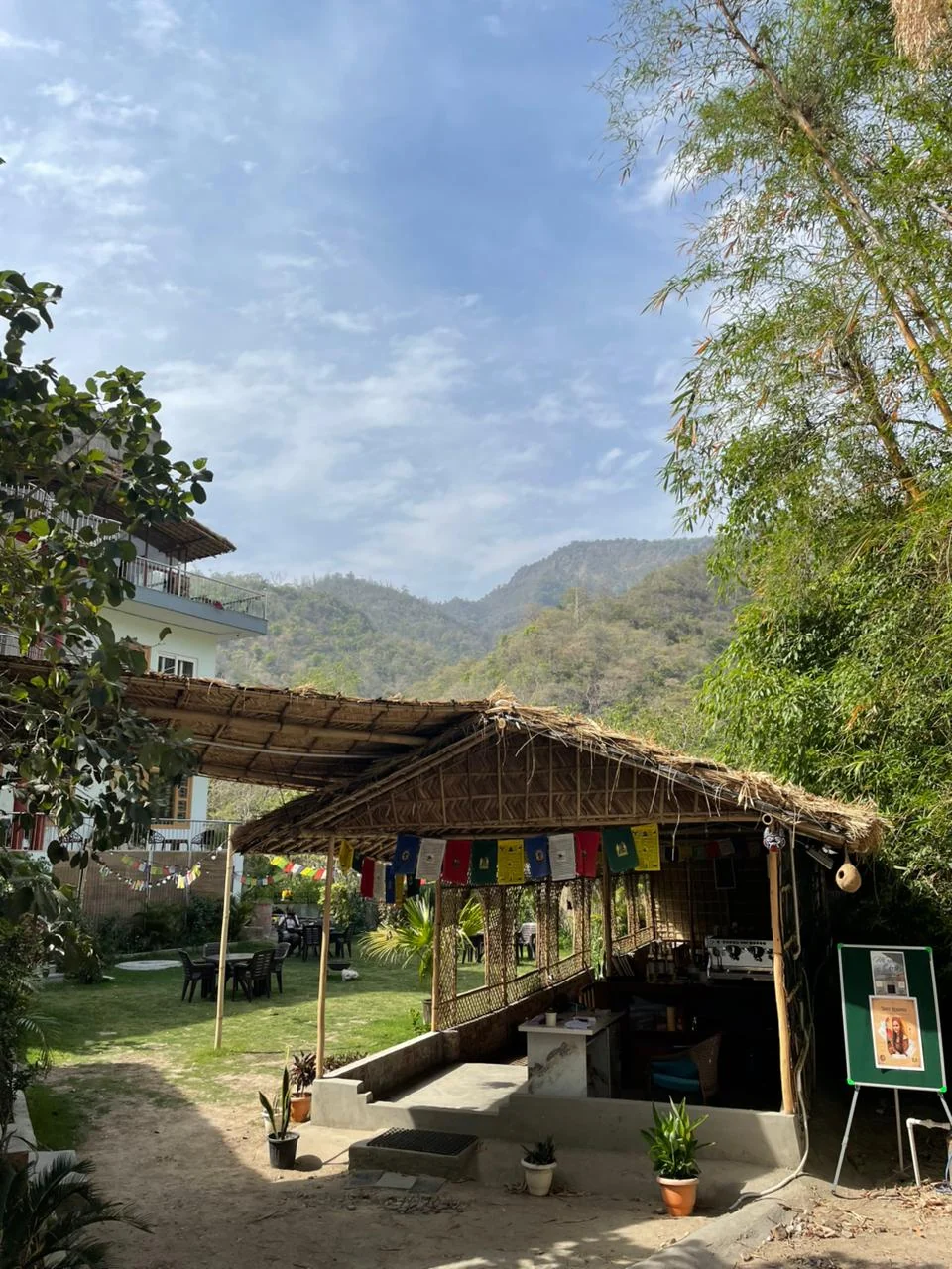 Bamboo-roof café and garden against the Tapovan hills